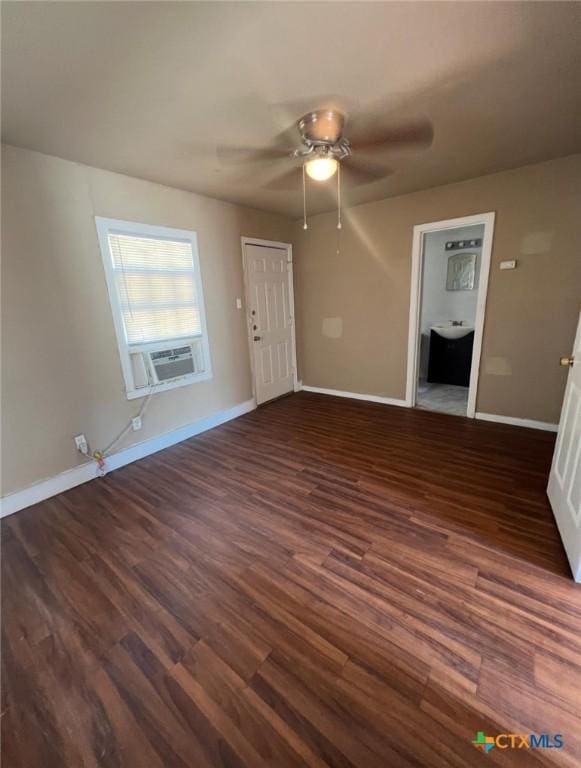 empty room featuring baseboards, a ceiling fan, wood finished floors, and cooling unit