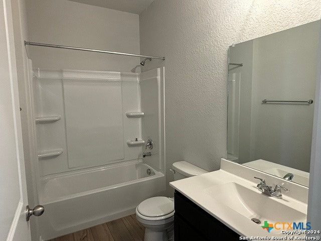 full bathroom with hardwood / wood-style floors, vanity, toilet, and bathtub / shower combination