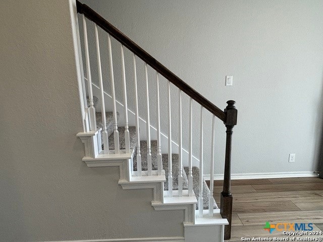 staircase featuring hardwood / wood-style floors