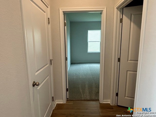 hall with dark hardwood / wood-style floors