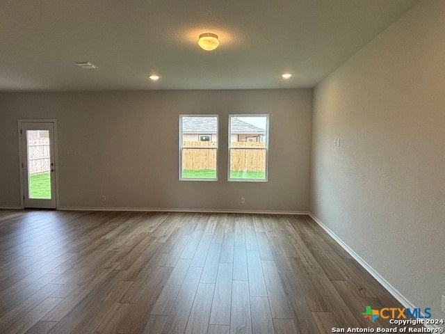 spare room with dark hardwood / wood-style floors