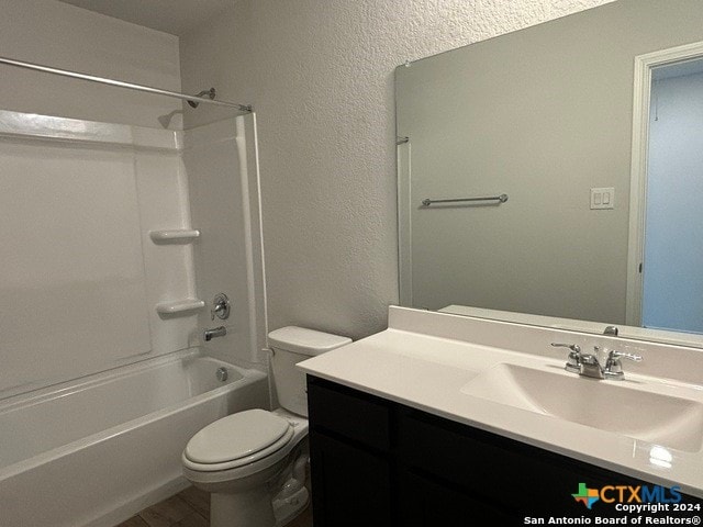 full bathroom featuring toilet, vanity, and shower / washtub combination