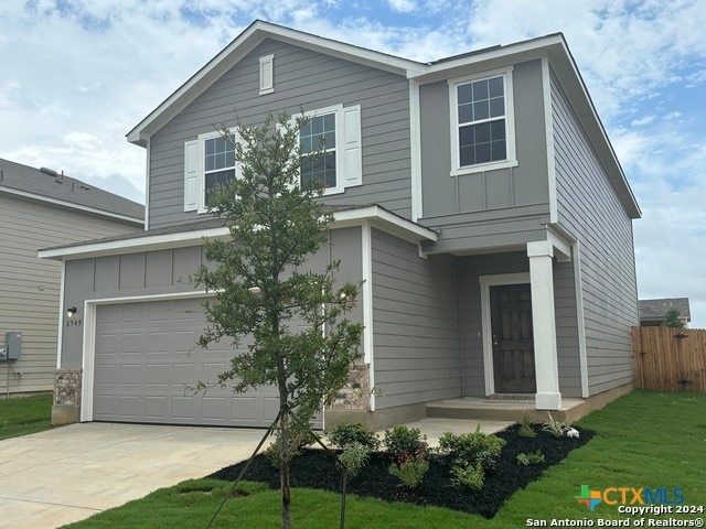 view of front facade with a garage and a front lawn