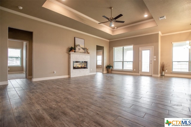 unfurnished living room with hardwood / wood-style flooring and a healthy amount of sunlight