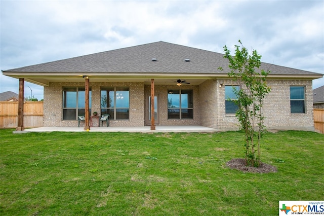 rear view of property featuring a lawn and a patio