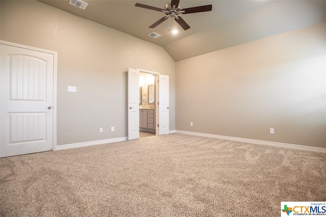 unfurnished bedroom with vaulted ceiling, light carpet, ceiling fan, and ensuite bath