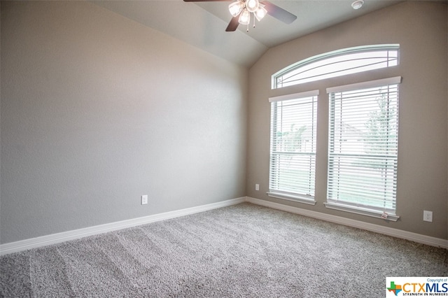 empty room featuring carpet flooring, ceiling fan, and vaulted ceiling