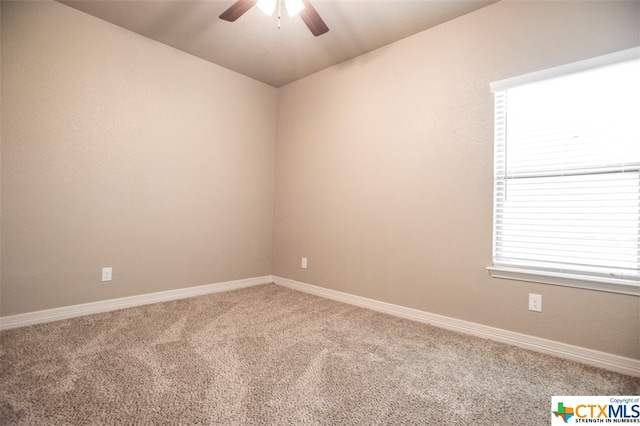 empty room featuring carpet flooring, ceiling fan, and plenty of natural light