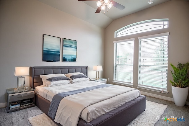 bedroom featuring lofted ceiling, light colored carpet, and ceiling fan