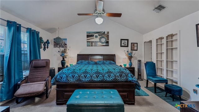 carpeted bedroom with ceiling fan and vaulted ceiling