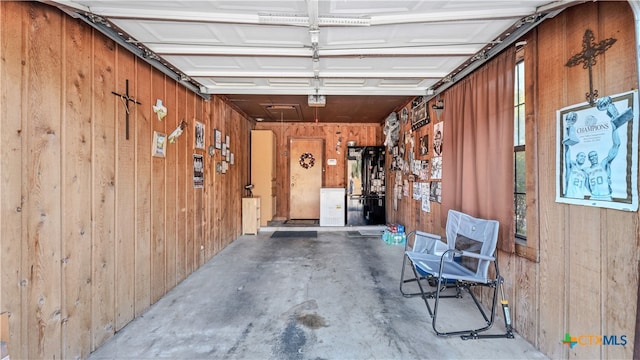 garage featuring wooden walls and a garage door opener