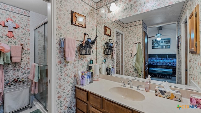 bathroom featuring vanity, an enclosed shower, and ceiling fan