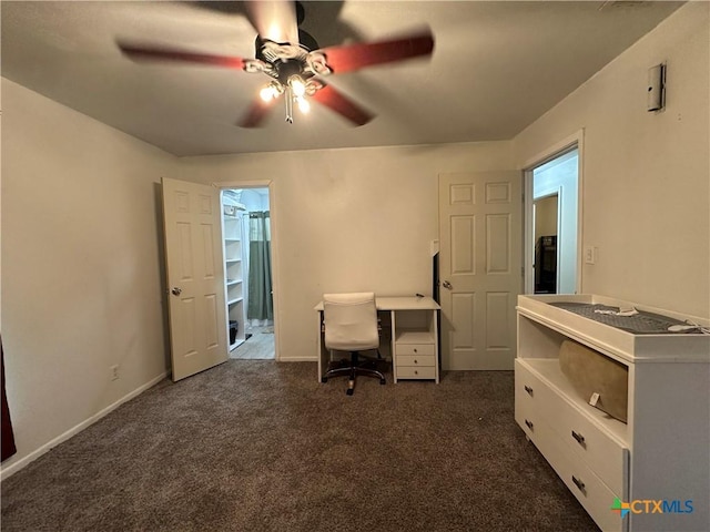 unfurnished office with dark colored carpet and ceiling fan