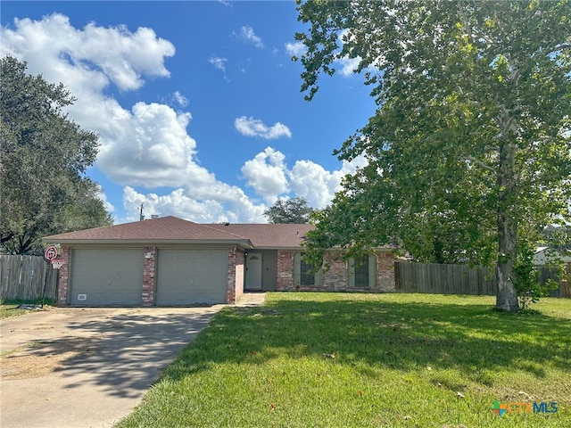 ranch-style house with a garage and a front yard