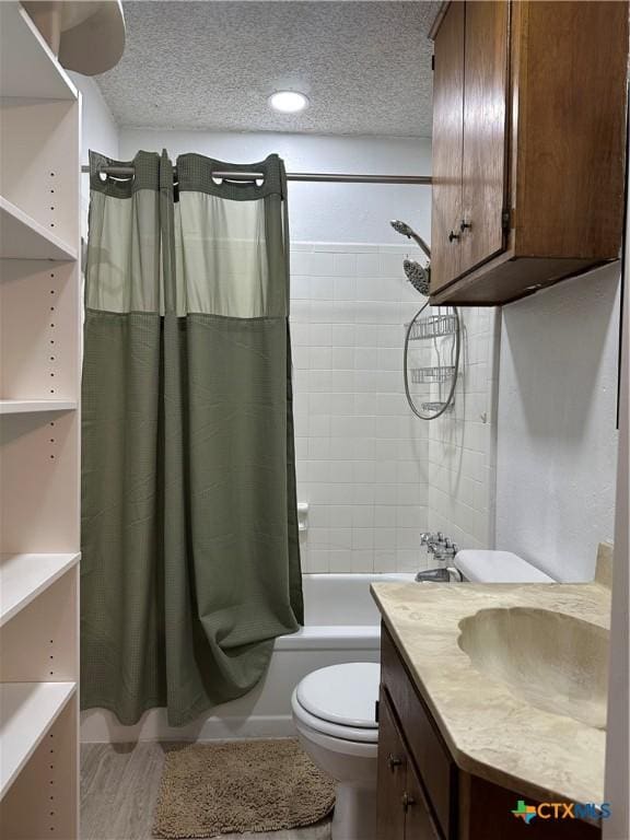 full bathroom with shower / tub combo, vanity, a textured ceiling, and toilet