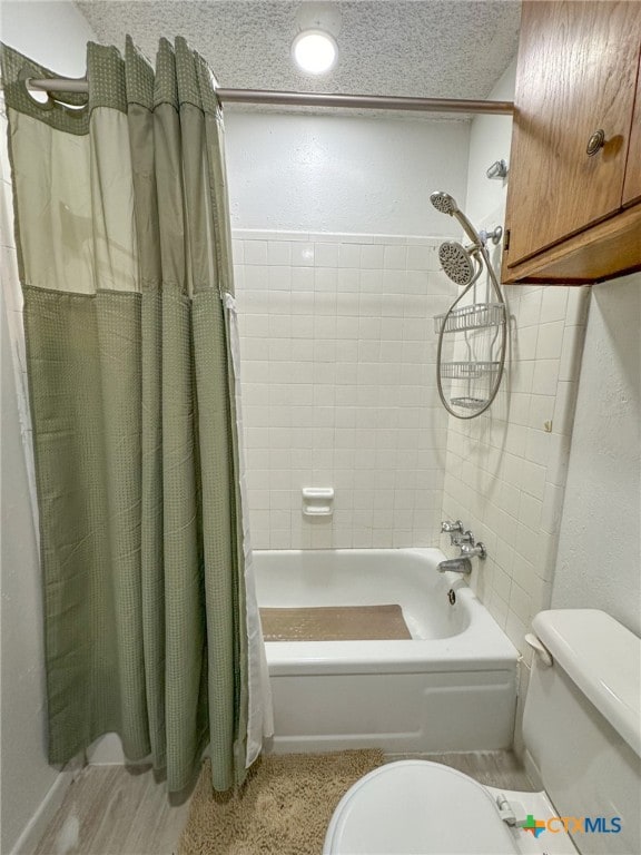 bathroom featuring hardwood / wood-style floors, a textured ceiling, toilet, and shower / bath combo with shower curtain