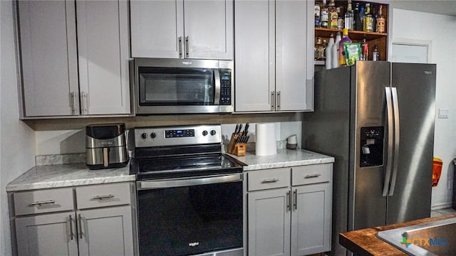 kitchen featuring gray cabinets and stainless steel appliances