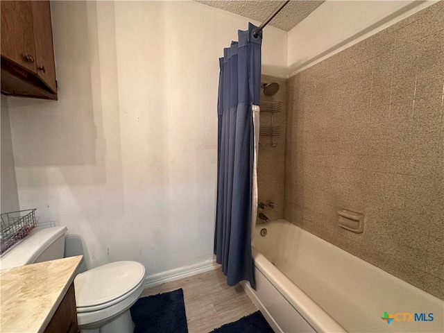 full bathroom with wood-type flooring, a textured ceiling, toilet, vanity, and shower / tub combo