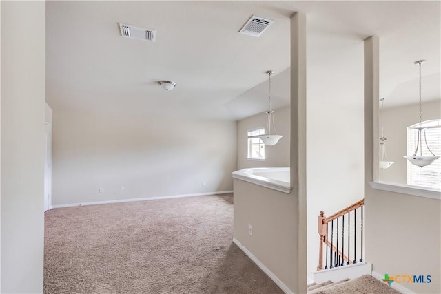 unfurnished room featuring carpet floors and baseboards