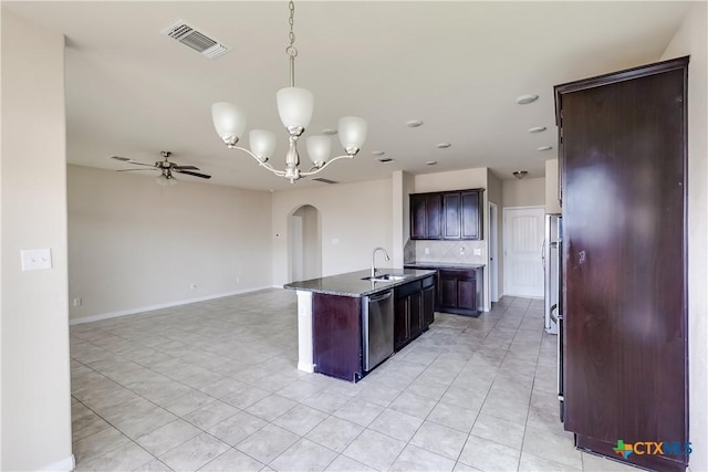 kitchen featuring stainless steel appliances, a sink, ceiling fan, arched walkways, and tasteful backsplash