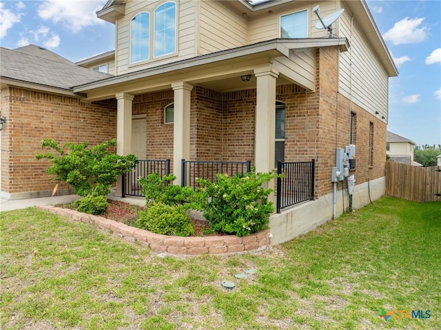 property entrance featuring brick siding and a porch