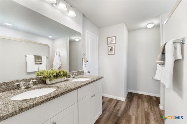 6038 Ballast Trl, New Braunfels, TX 78132 - full bath with wood finished floors, double vanity, and baseboards
