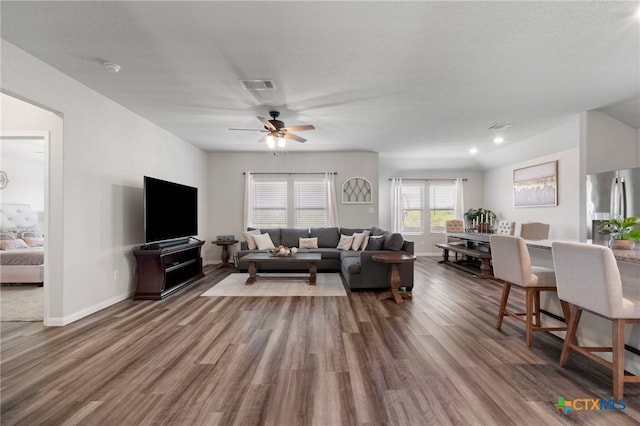 6038 Ballast Trl, New Braunfels, TX 78132 - living room featuring wood finished floors, a ceiling fan, and baseboards