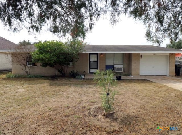 ranch-style home with a garage, cooling unit, and a front yard