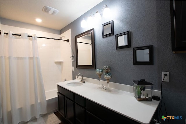 bathroom with shower / bath combination with curtain and vanity