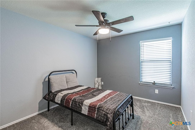 bedroom featuring ceiling fan, carpet, and a textured ceiling