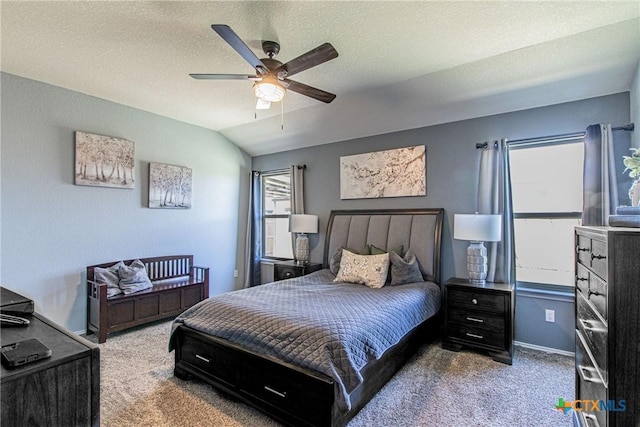 carpeted bedroom with ceiling fan, vaulted ceiling, and a textured ceiling