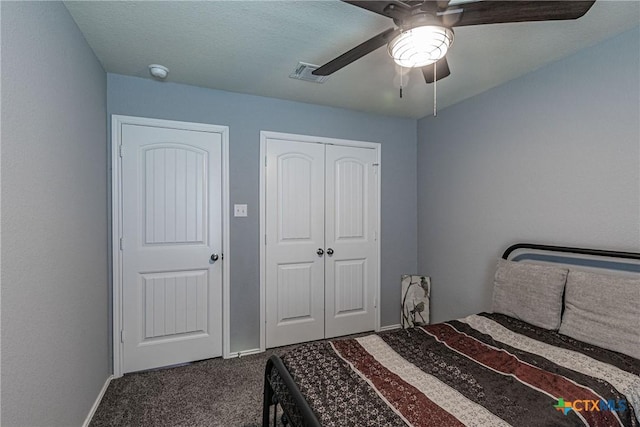 carpeted bedroom with ceiling fan and a closet