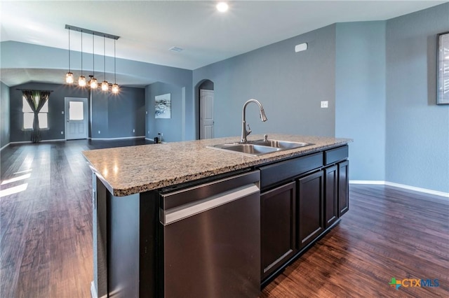 kitchen featuring sink, dishwasher, dark hardwood / wood-style floors, decorative light fixtures, and an island with sink