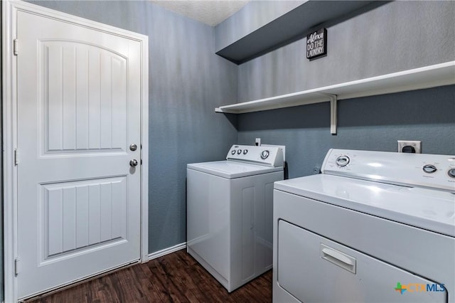 clothes washing area with washing machine and dryer and dark wood-type flooring