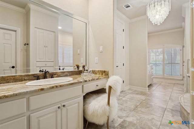 bathroom with ornamental molding, a chandelier, and vanity