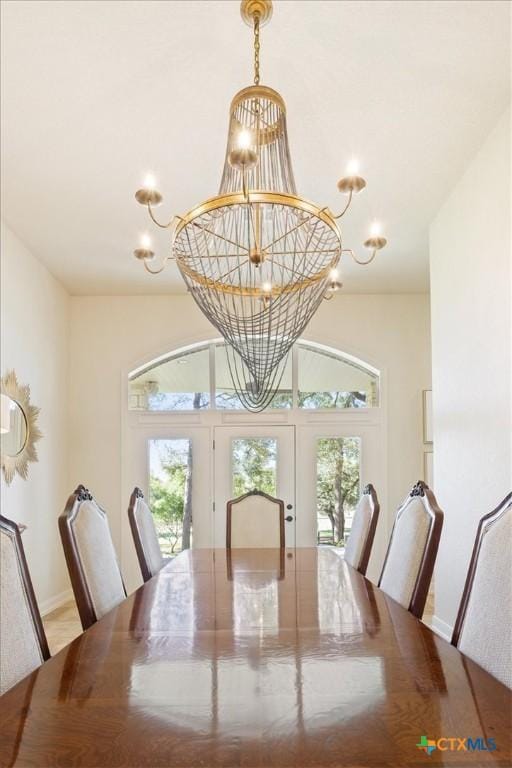 dining area featuring a notable chandelier, french doors, and a wealth of natural light