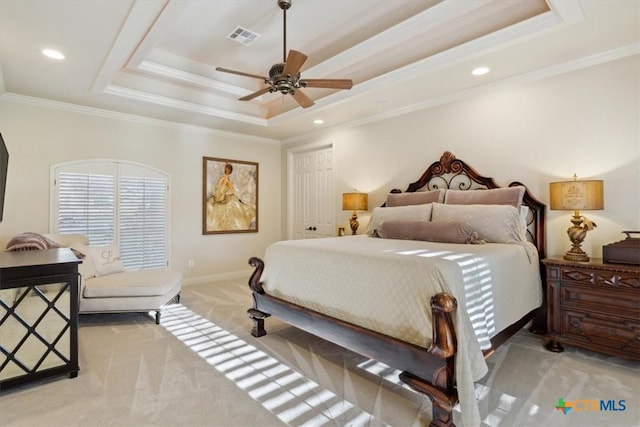 carpeted bedroom featuring a raised ceiling, ceiling fan, and crown molding