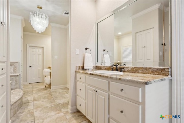 bathroom with ornamental molding, a notable chandelier, and vanity