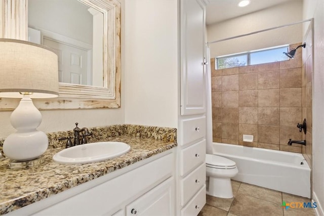 full bathroom with tile patterned flooring, toilet, vanity, and tiled shower / bath