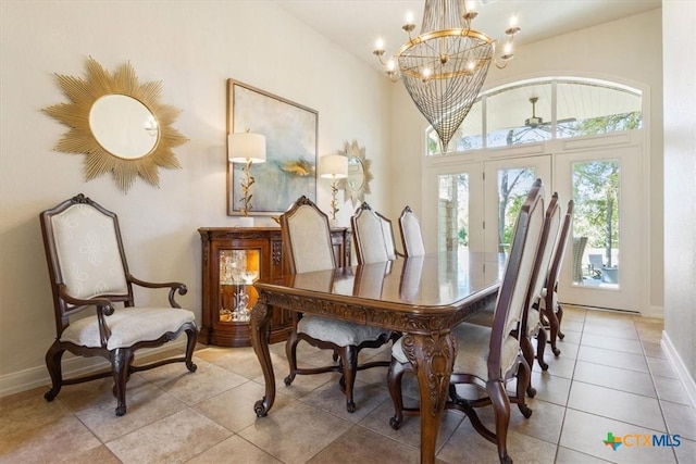 dining area featuring light tile patterned flooring, french doors, and a chandelier