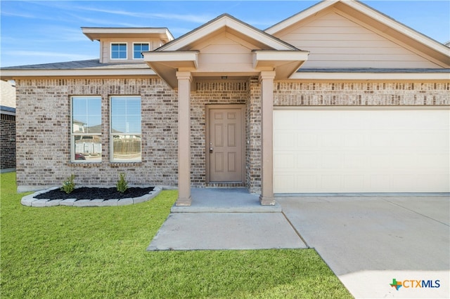 view of front facade with a front lawn and a garage