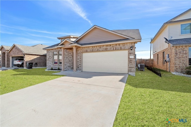 ranch-style home with a garage, central air condition unit, and a front yard