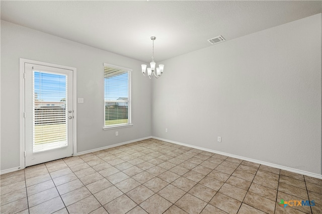 unfurnished room featuring light tile patterned floors and an inviting chandelier