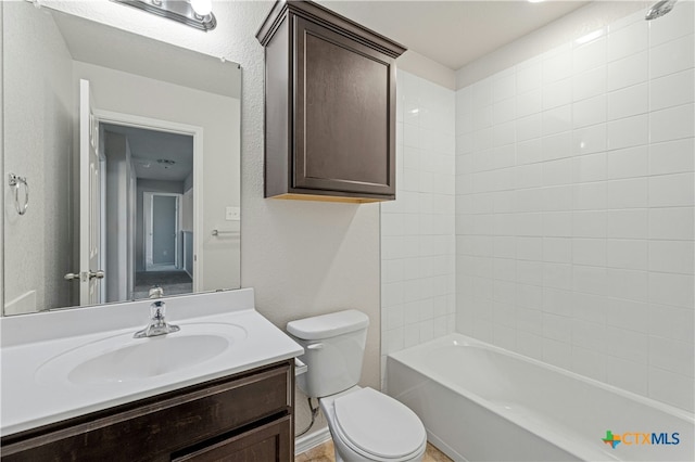 full bathroom with vanity, toilet, and tiled shower / bath