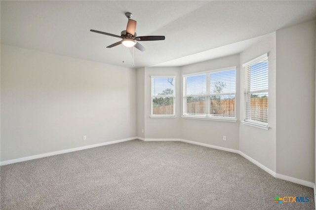 carpeted spare room with ceiling fan