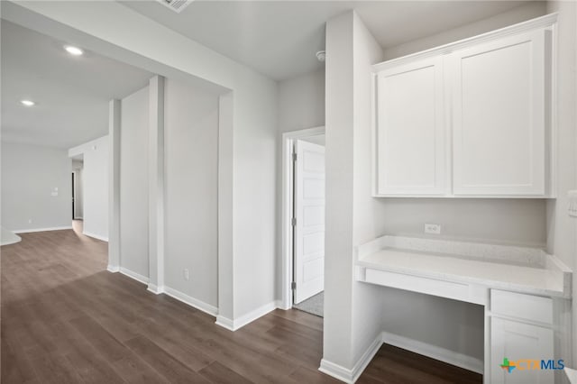 corridor with dark hardwood / wood-style flooring