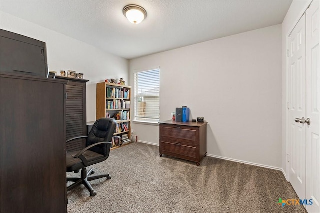 office area featuring a textured ceiling, carpet floors, and baseboards