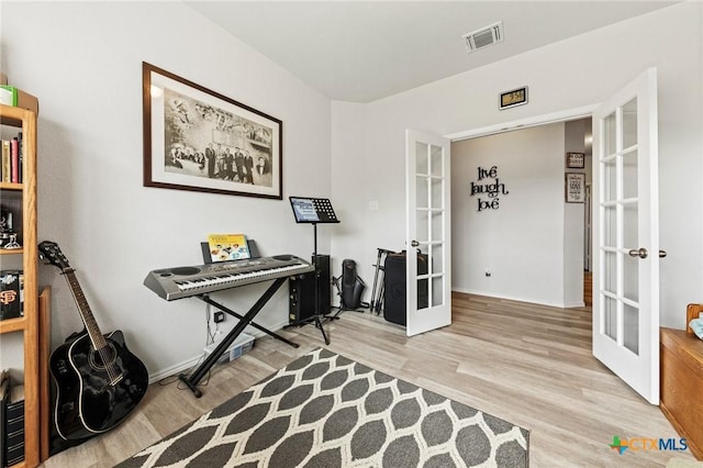 office area featuring french doors, wood finished floors, and visible vents