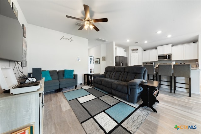 living room with a ceiling fan, recessed lighting, visible vents, and light wood finished floors