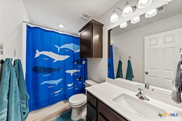 bathroom featuring a shower with curtain, visible vents, vanity, and toilet